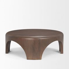 a wooden coffee table with curved legs and a circular top, on a white background