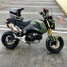 a green motorcycle parked in a parking lot