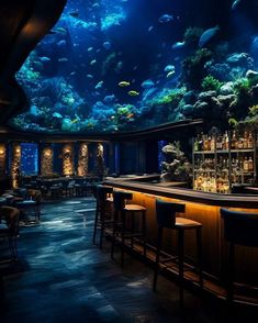 an aquarium is shown in the middle of a bar with several stools and tables