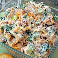 a casserole dish with cheese and other toppings in a glass container on a table