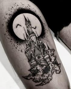 a man's leg with a castle tattoo on it