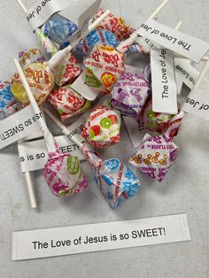 many lollipops are on the table next to some stickers that say love jesus so sweet