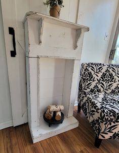 an old white cabinet is next to a chair