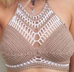 a close up of a woman wearing a brown and white crochet bra top