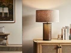 a table with a lamp and some books on it