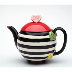 a black and white striped teapot with a red heart on top that says true love