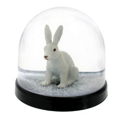 a snow globe with a white rabbit in it