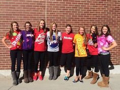 a group of young women standing next to each other in front of a brick wall