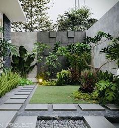 an outdoor garden with grass, rocks and plants