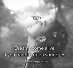 a woman with her eyes closed looking up at a butterfly on her forehead and the words dreams come alive if you dare to open your eyes