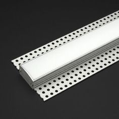 a metal shelf with holes on it and a white strip hanging from the bottom to the top