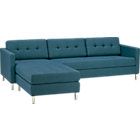 a blue sectional couch sitting on top of a white floor