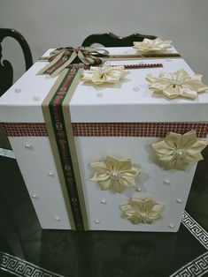 a large white box with gold bows on it