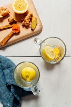 lemons, ginger and ginger water on a cutting board