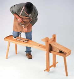 a man is working on a wooden bench