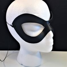 DESCRIPTIONAdd spice to your love life! This small, very lightweight, black leather mask is perfect for the beginner dominatrix or Lord of the Bedroom. Any color. Silver studs available. Waterproofed leather, glossy or matte finish, & several choices to affix the mask (cord, elastic, ribbon, waterproof cord, stick, or no holes for adhesive). Measurements: 3" high x 7" wide (tallest & widest points); 1" high between the eyes; 2.75" wide x 2.75" tall eye openings ---------------------------------- Lone Ranger Costume, Splatoon Costume, Mask Cord, Robin Superhero, Comicon Costume, Ranger Costume, New Years Eve Ball, Robin Cosplay, Black Wear