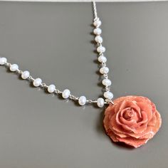 "Real Rose Necklace - Real Pink Miniature Rose preserved in resin. It is suspended from a Sterling Silver Chain accented with tiny White Freshwater Pearls. Rose is approximately 1\" - 1.25\" Sterling Silver Chain and Findings 17\" Length Each rose is unique so the one you will receive, may vary slightly from the one pictured. This is a stock photo. Be sure to check out my Floral Collection for similar items. http://www.etsy.com/shop/mcstoneworks?section_id=6939810" Pearl Necklace Real, Miniature Rose, Real Flower Necklace, Real Pearl Necklace, Jewelry Nature, Wedding Bridesmaid Jewelry, Real Rose, Necklace Flower, Pearl Jewelry Necklace