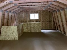 an unfinished room with wooden walls and flooring in the process of being built into the ceiling