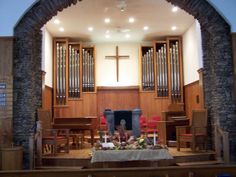 an empty church with pews and organ pipes