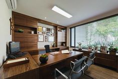 an office with wood paneling and large windows