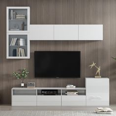 a living room with white furniture and a large flat screen tv mounted on the wall