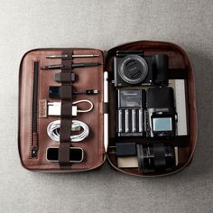 an open brown case with various items inside