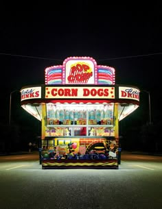 a carnival booth at night with lights on