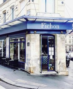 an old building with a blue awning on the front and windows that says fifoon