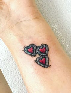 a woman's arm with two hearts on it