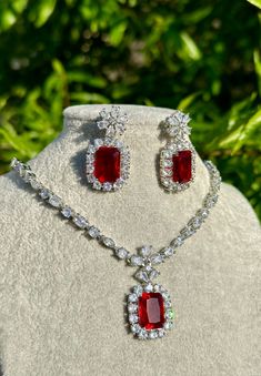 Handmade  Style: Necklace and Earrings Set Material: Platinum Plated, Lab Simulated Ruby and White Sapphire Stones Imported Please Note: This necklace and earrings are sold as a set. Item Number: 7078R Luxury Elegant Ruby Beaded Necklaces, Luxury Vintage Ruby Necklace, Luxury Red Dangle Jewelry, Fine Ruby Drop Earrings Jewelry, Elegant Ruby Jewelry Sets With Matching Earrings, Fine Ruby Drop Earrings, Formal Pendant Jewelry With Stones, Crystal Necklace And Earring Set For Gifts, Wedding Drop Earrings With Stones