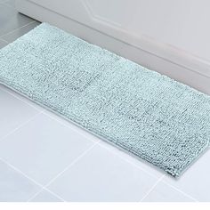 a bath mat sitting on top of a bathroom floor