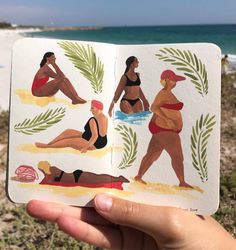 a person holding up an open book with pictures of people on it in front of the beach