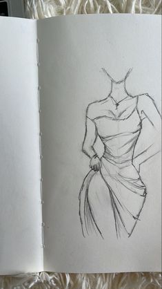 an open book with a drawing of a woman in a dress