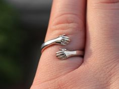 "Copy and paste into your browser, get 15% off ➔ https://bit.ly/VD15OFF This hug ring makes a perfect gift for friends and couples. Crafted from stainless steel, it's a meaningful symbol of your bond. A truly special promise ring, it's perfect for celebrating love, friendship, and commitment. DETAILS: -One Ring -Ring is Stainless Steel -18mm from top of one hand to bottom of the other -4mm wide You will receive one hug ring. **Every item is handmade, this means that each will be unique and may not look EXACTLY like the picture, but it will look very similar ➡ORDER PROBLEMS If there are any problems with your order please contact me, my goal is for you to be happy with your products and I will do what I can to help! ➡BULK ORDERS I gladly make bulk orders! For every bulk order of 15+, there Nickel-free Open Midi Rings For Gifts, Gift Hypoallergenic Open Midi Ring, Gifts For Long Distance Friends, Couples Long Distance, Hug Ring, Long Distance Friends, Distance Friendship, Best Friend Birthday Gift, Long Distance Friendship