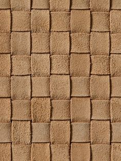 a brown brick wall with small squares on it