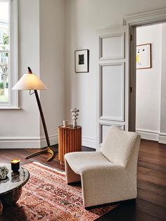 a living room filled with furniture and a lamp