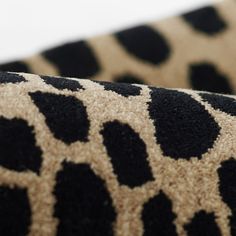 a close up view of a black and brown animal print fabric