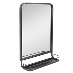 a large mirror sitting on top of a metal shelf