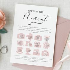 a pink and white wedding save the date card on top of a table with flowers