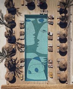 an aerial view of a swimming pool surrounded by palm trees