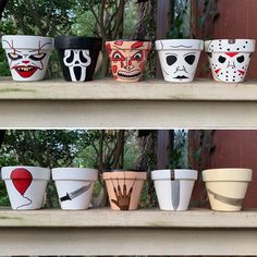 several pots with painted faces on them are lined up in front of each other,