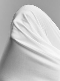 a black and white photo of a person wrapped in a blanket