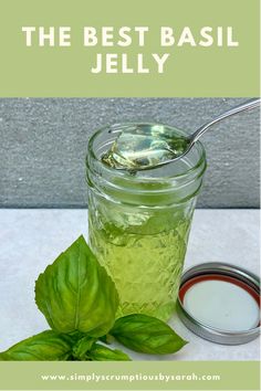 the best basil jelly recipe in a mason jar with fresh basil leaves next to it