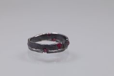 A stunning unique sterling silver ring band with 5 rough rubies set on it by  casting the silver on it. Unusual and one of a kind and it is 10 and 1/2  US ring size.  This ring is made especially for those who wish to feel special by wearing one-of-a-kind jewelry, every day, with a bit of magic from a beach sand in the Mediterranean Sea. It is totally handmade by me in my atelier NYAMI  in Italy, using the ancient sand casting method, where molten sterling silver is poured into the ring mould ac Unique Handmade Red Ruby Ring, Handmade Artisan Red Rings, Rough Silver Ring, Handmade Spiritual Sterling Silver Ruby Ring, Handmade Sterling Silver Ruby Ring, Open Style, Oxidized Silver Rings, Sterling Silver Rings Bands, Size 10 Rings, Ruby Ring