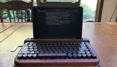 an old typewriter sitting on top of a wooden table