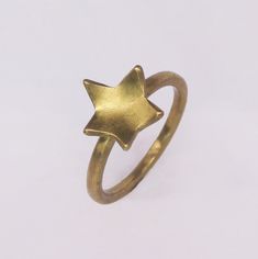 Delicate gold-coloured Star Stacker Rings. Perfect to wear alone and by stacking it with your other favourite rings. These lovely Star Stackings rings are available in brass (gold colour), silver or 18K gold plating. Size: UK A - UK Q Thickness: 1,5 mm Width: 2 mm Star detail: around 10 x 10 mm Please note: The 18K gold-plated jewellery will take 10 business days to prepare. The processing time for the silver and brass jewellery is 1-3 working days. Gold Star Ring, Wide Gold Ring, Silversmithing Jewelry, Triple Band Ring, Minimalist Silver Ring, Gold Minimalist Jewelry, Brass Jewellery, Mens Band Rings, Stacker Rings