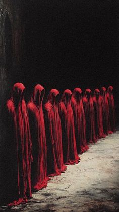 a group of people standing in a line with red cloths on their heads and body