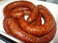 two large sausages are on a white plate