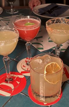 three glasses filled with different types of drinks