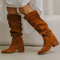 The Easton Cognac Color Suede Slouchy Boots offer a relaxed style with comfort padding and a recycled rubber outsole, perfect for all day wear. Key Features: Soft Suede: Crafted from high-quality suede in a warm cognac shade. Comfort Padding: Microsuede insole with added padding for all-day comfort. Relaxed Style: Slouchy design for a laid-back look.. Convenient Pull-On Design: Easy to wear with a simple pull-on closure. Stacked Leather Heel: Provides stability and a touch of height. Versatile F Cognac Suede Boots, Brown Suede Tall Boots, Suede Boots With Dress, Tan Suede Boots Outfit, Slouch Boots Outfit, Suede Boots Outfit, Tall Boots Outfit, Slouchy Suede Boots, Tan Suede Boots